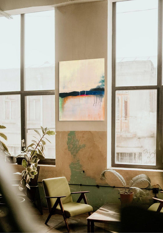 Original oil painting 'Where the Sky Remembers' displayed in a modern living room with large windows.