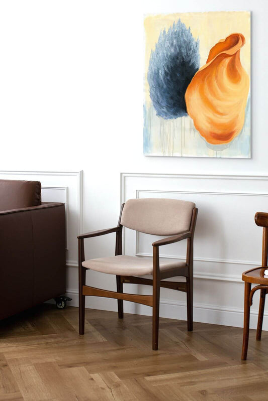 Stylish living room featuring a beige chair and an original oil painting, "Whisper of Shell and Smoke".