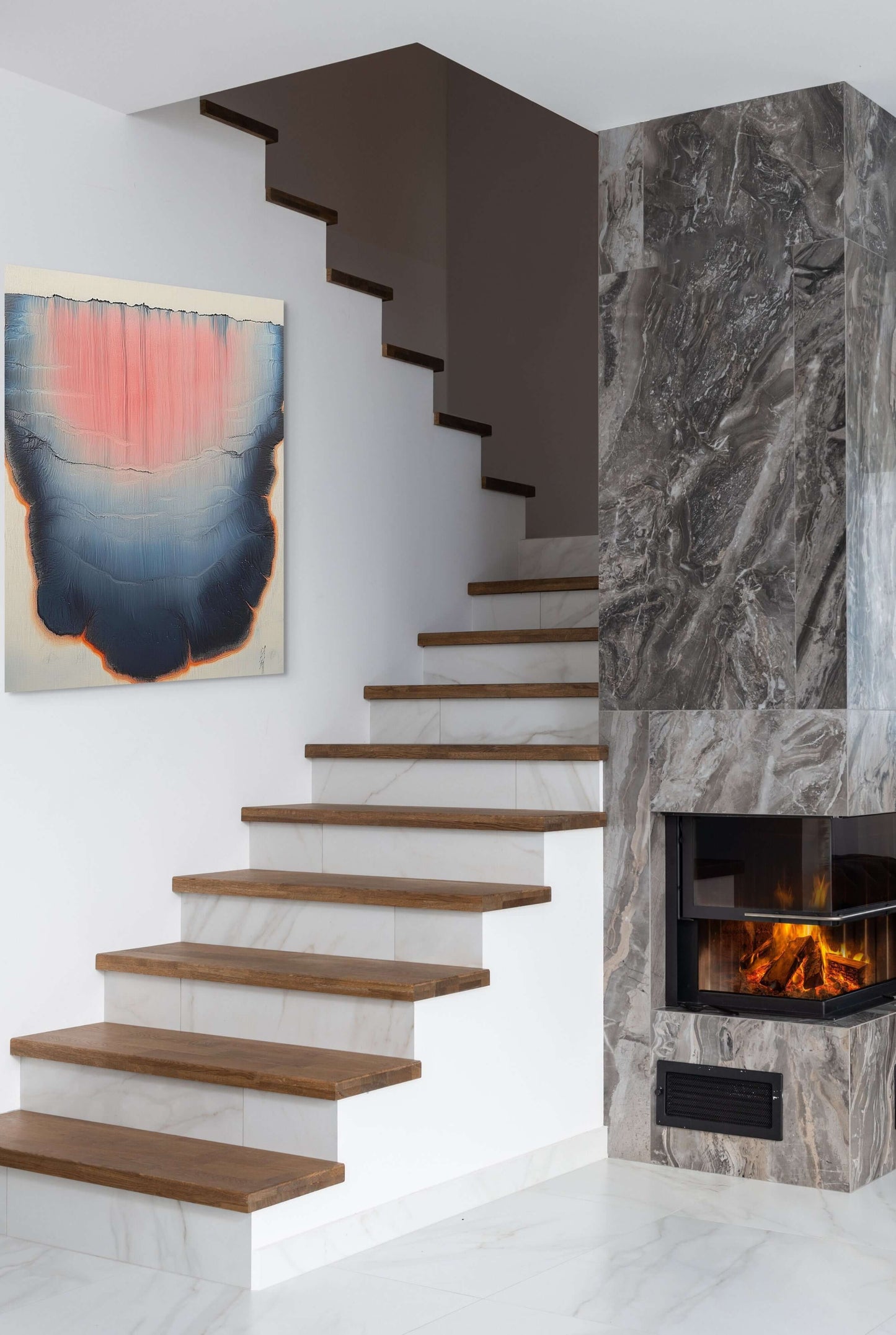 Modern staircase featuring original oil painting 'Lumen Descent' by PAINT POET, with elegant wood accents.